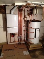 Boiler and water cylinder installed in a basement